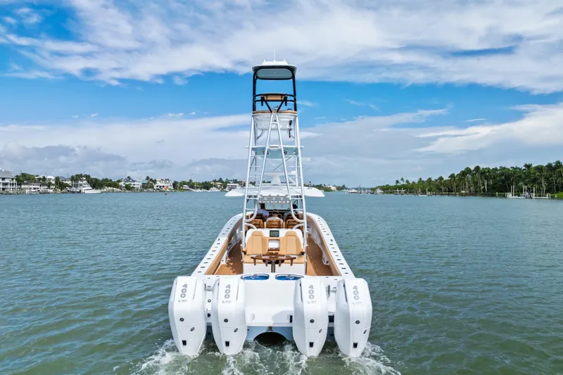  Yacht Photos Pics 2025 Freeman LR boat with four engines cruising on a scenic waterway.
