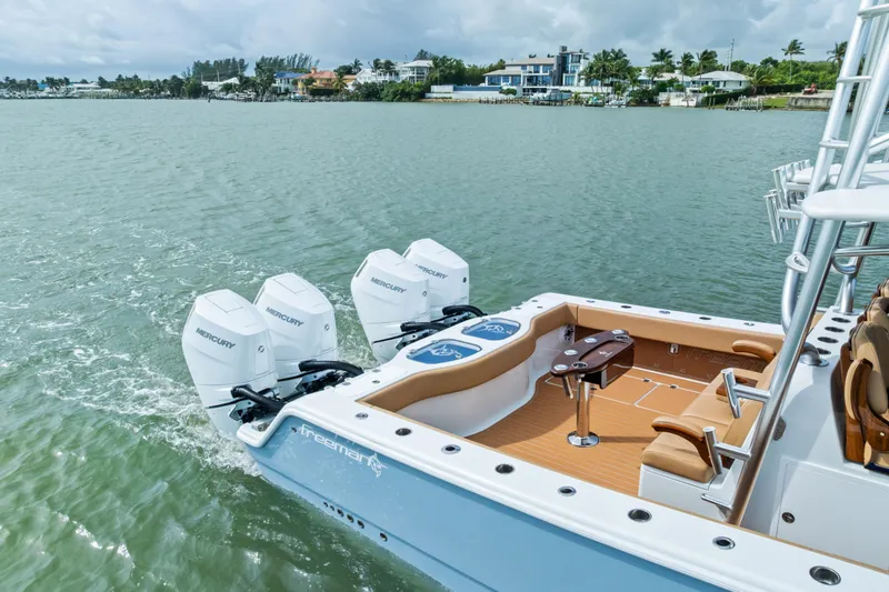  Yacht Photos Pics 2025 Freeman LR boat with Mercury engines on a calm waterway.