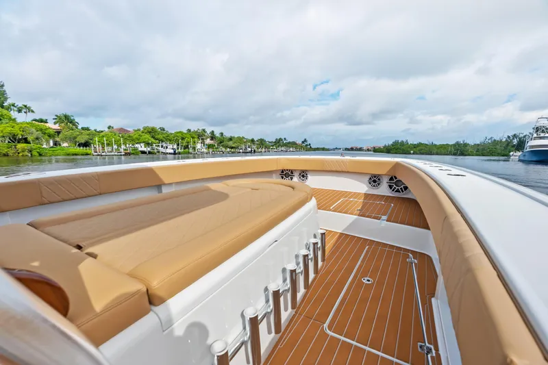  Yacht Photos Pics Luxurious 2025 Freeman LR boat interior with tan seating and sleek design on a scenic waterway.