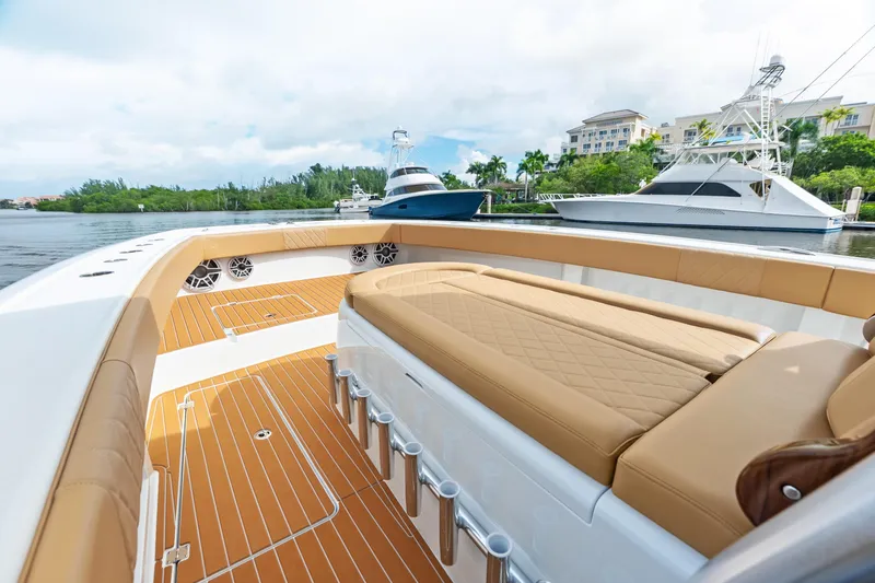  Yacht Photos Pics Luxurious 2025 Freeman LR boat interior with tan seating and sleek design, docked by waterfront.