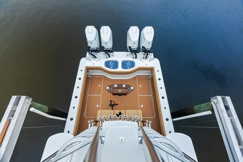  Yacht Photos Pics Aerial view of 2025 Freeman LR boat deck with four engines on calm water.