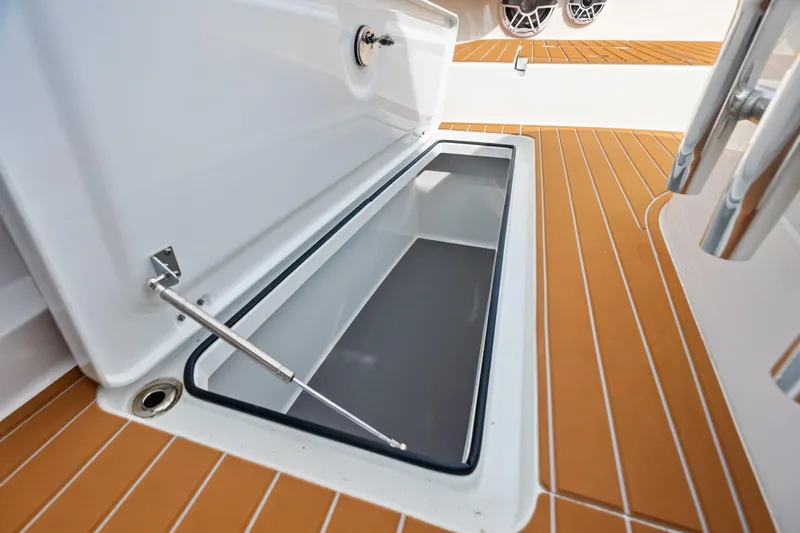  Yacht Photos Pics Open storage compartment on 2025 Freeman LR boat with teak flooring.