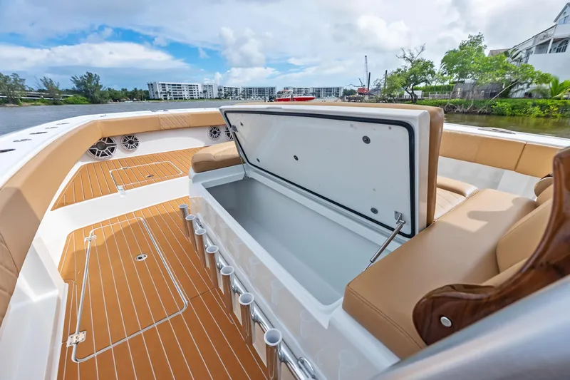  Yacht Photos Pics 2025 Freeman LR boat interior with open storage compartment and tan seating.