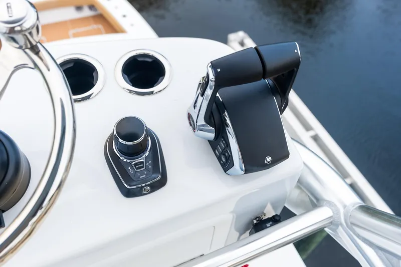  Yacht Photos Pics Control panel of 2025 Freeman LR boat with steering wheel and throttle levers.