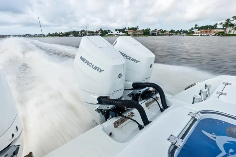  Yacht Photos Pics Twin Mercury engines powering a 2025 Freeman LR boat on a scenic waterway.
