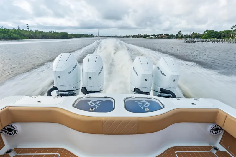  Yacht Photos Pics 2025 Freeman LR boat with four Mercury engines cruising on a river.