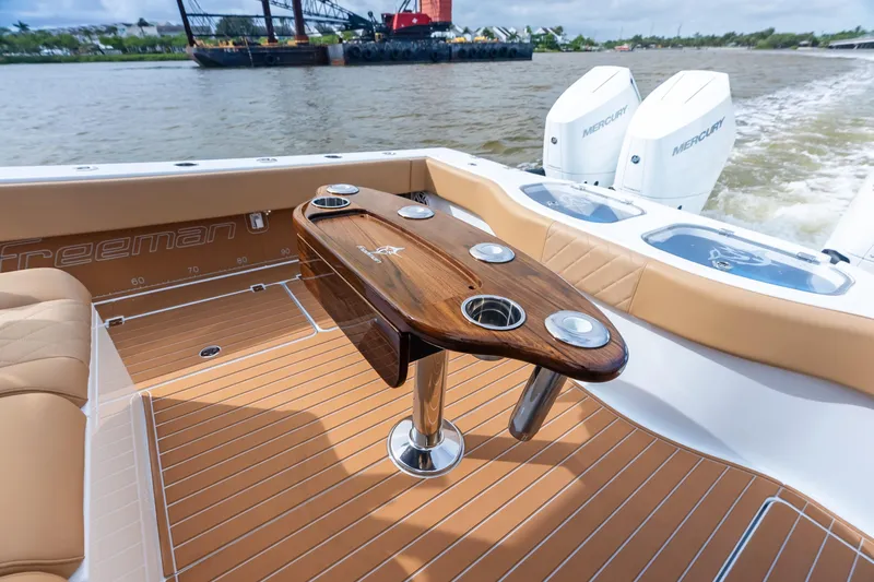  Yacht Photos Pics Luxury Freeman LR 2025 boat interior with wooden table and dual Mercury engines.