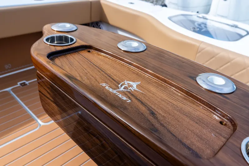  Yacht Photos Pics Luxurious 2025 Freeman LR boat interior with polished wood finish and cup holders.