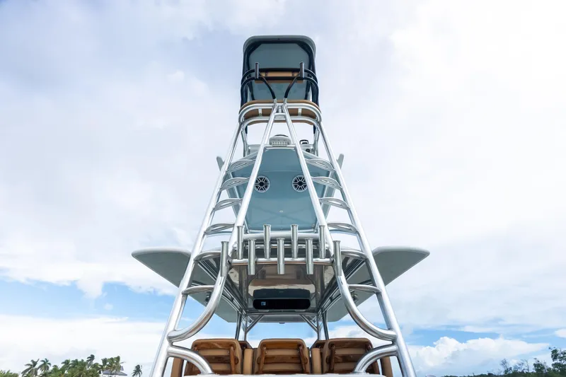  Yacht Photos Pics 2025 Freeman LR boat tower against a cloudy sky, showcasing sleek design and structure.