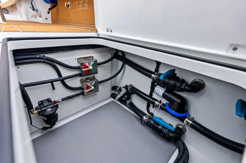  Yacht Photos Pics 2025 Freeman LR boat plumbing system with valves and hoses in storage compartment.