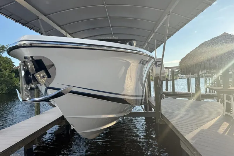  Yacht Photos Pics 2025 Nor-Tech 390 Sport Center Console boat docked under a canopy.