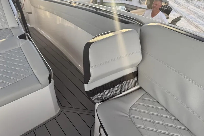  Yacht Photos Pics 2025 Nor-Tech 390 Sport Center Console interior with gray quilted seating and sleek design.
