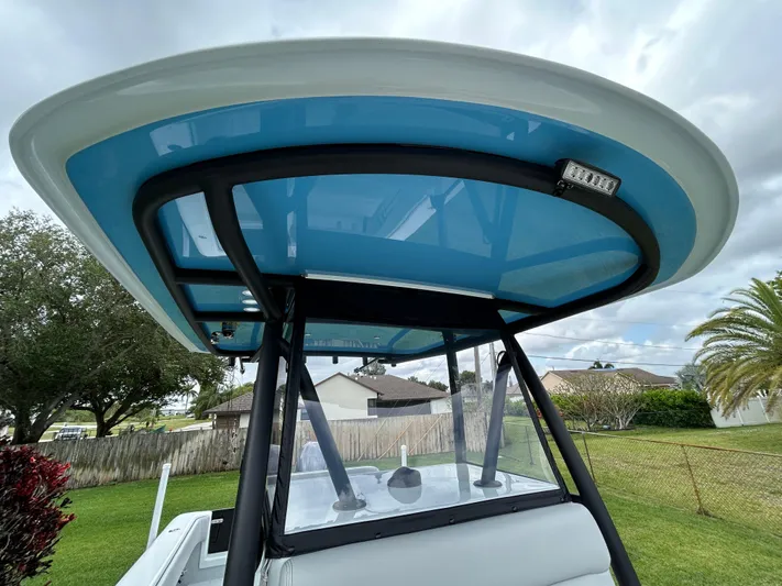  Yacht Photos Pics 2024 Contender 28 Tournament boat with blue T-top, parked outdoors.