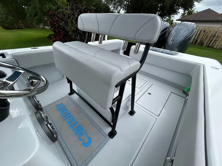  Yacht Photos Pics 2024 Contender 28 Tournament boat interior with white seating and steering wheel.