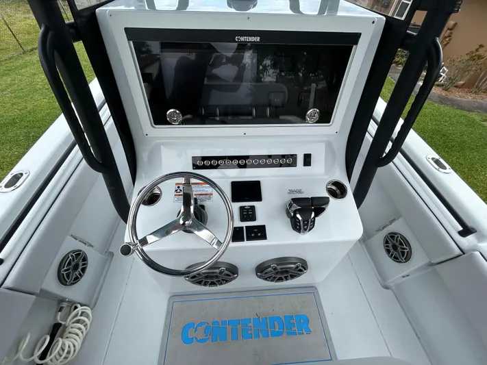 Yacht Photos Pics 2024 Contender 28 Tournament boat dashboard with steering wheel and controls.