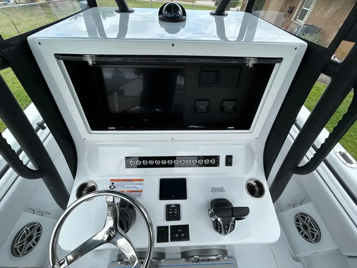  Yacht Photos Pics 2024 Contender 28 Tournament boat dashboard with steering wheel and control panel.