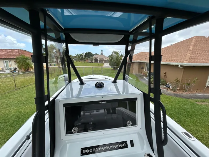  Yacht Photos Pics 2024 Contender 28 Tournament boat console with T-top, in a residential backyard setting.