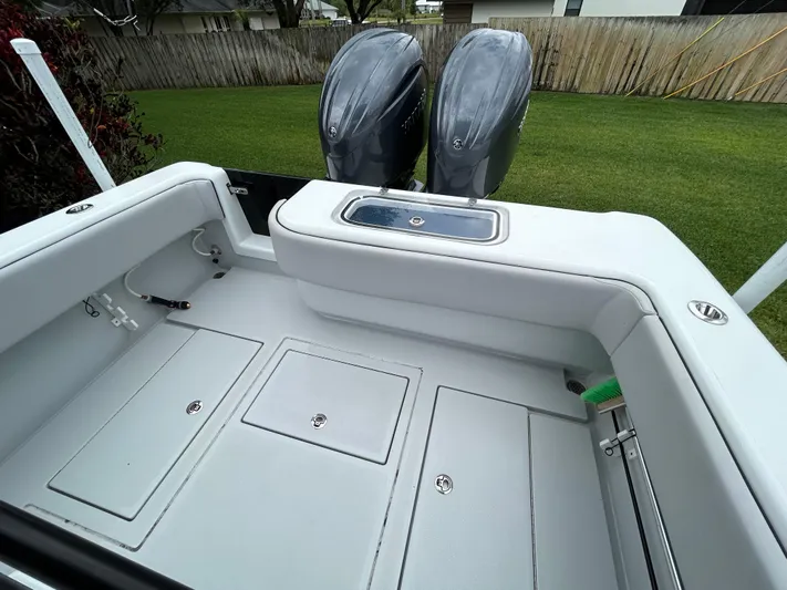  Yacht Photos Pics 2024 Contender 28 Tournament boat deck with dual outboard motors, spacious storage, and sleek design.