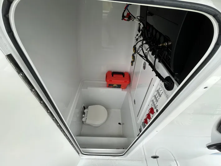 Yacht Photos Pics 2024 Contender 28 Tournament boat interior with toilet and wiring panel.