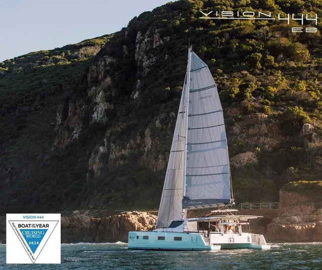 Vision 444 Yacht Photos Pics Sailing catamaran Vision 444, 2026 model, cruising near rocky coastline, awarded Boat of the Year 2024.