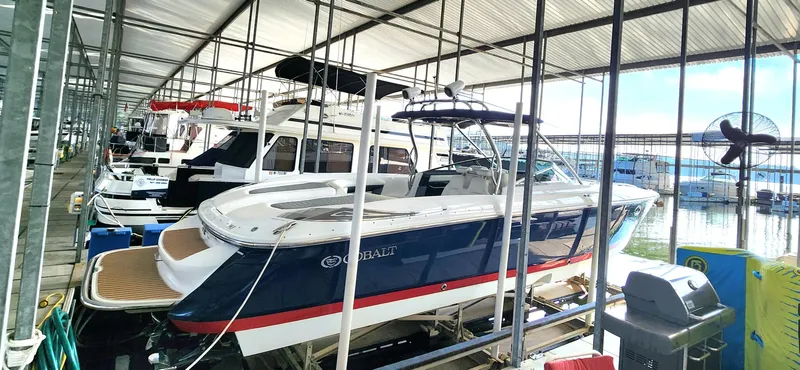  Yacht Photos Pics 2007 Cobalt 343 boat docked in a marina under a covered structure.