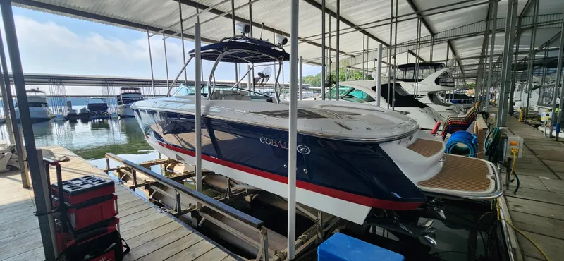  Yacht Photos Pics 2007 Cobalt 343 boat docked in a marina under a covered structure.