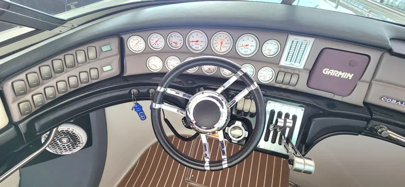  Yacht Photos Pics 2007 Cobalt 343 dashboard with steering wheel, gauges, and Garmin navigation system.