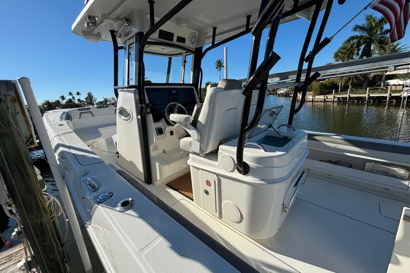  Yacht Photos Pics 2023 World Cat 295 CC boat interior with helm, seating, and water view.