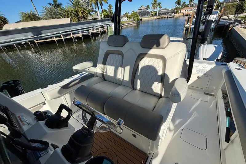  Yacht Photos Pics 2023 World Cat 295 CC boat interior with plush seating and steering controls.