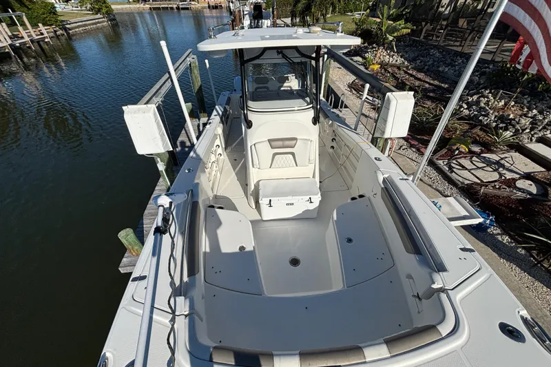  Yacht Photos Pics 2023 World Cat 295 CC boat docked, showcasing spacious deck and seating area.