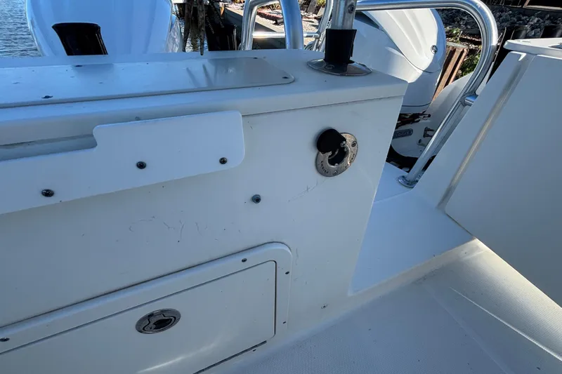  Yacht Photos Pics 2023 World Cat 295 CC boat interior with storage compartment and railing.