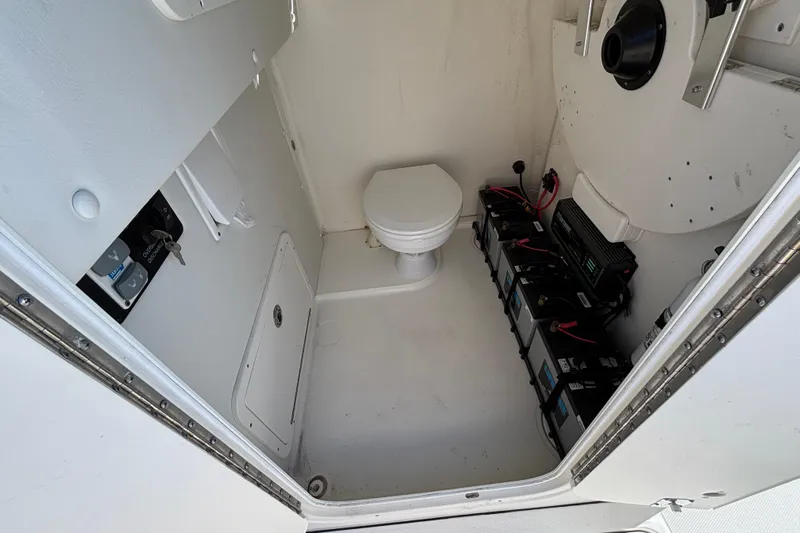  Yacht Photos Pics 2023 World Cat 295 CC interior with marine toilet and battery setup.