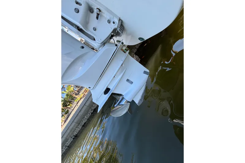  Yacht Photos Pics 2023 World Cat 295 CC boat engine in water, showcasing propeller and hull design.