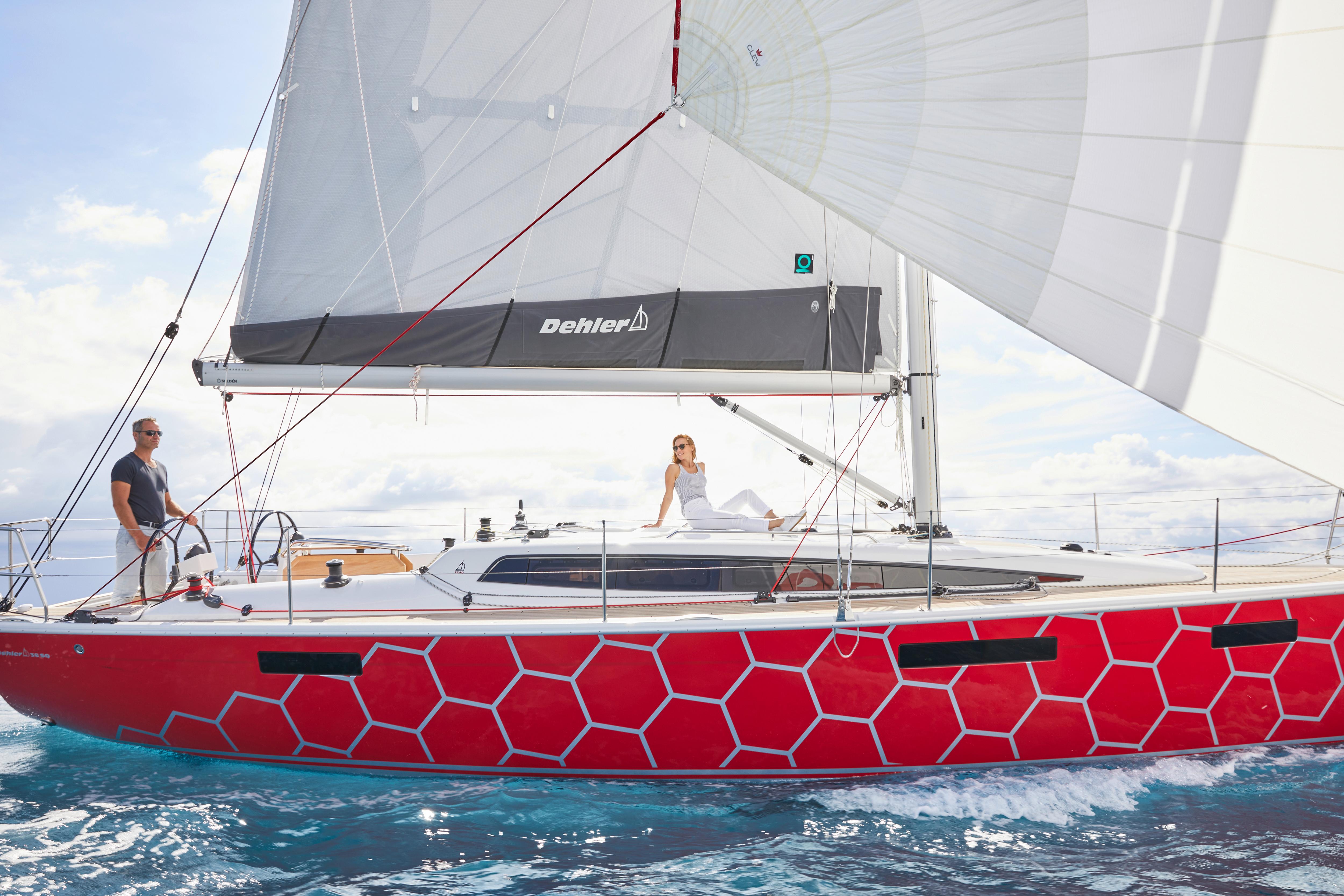 2025 Dehler 38 SQ sailboat with red hexagonal pattern sailing on open water.