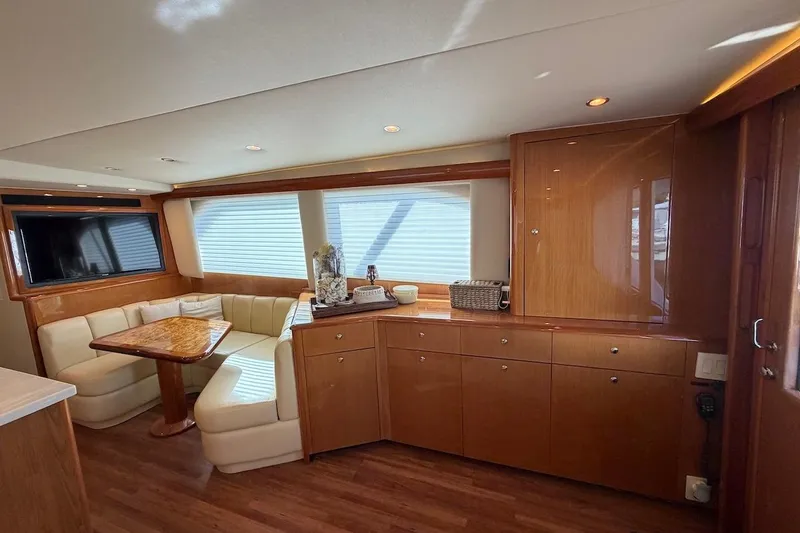 Breakaway Yacht Photos Pics Luxurious interior of 2004 Viking 56 Convertible yacht with elegant wood finishes and seating area.