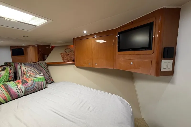 Breakaway Yacht Photos Pics Luxurious cabin interior of 2004 Viking 56 Convertible yacht with TV and colorful bedding.