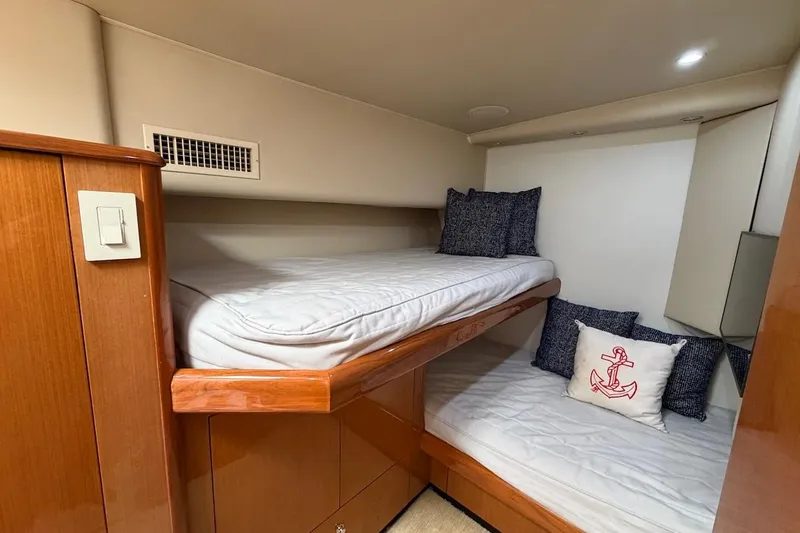 Breakaway Yacht Photos Pics 2004 Viking 56 Convertible yacht cabin with bunk beds and nautical-themed pillows.