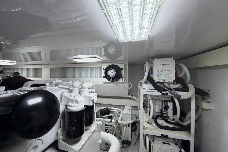 Breakaway Yacht Photos Pics Engine room of a 2004 Viking 56 Convertible yacht, featuring mechanical components and lighting.