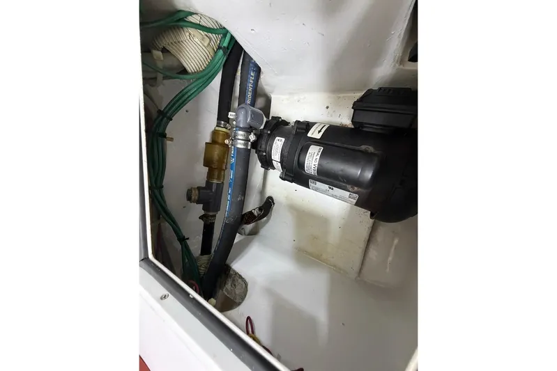 Breakaway Yacht Photos Pics Engine compartment of 2004 Viking 56 Convertible with visible hoses and pump system.