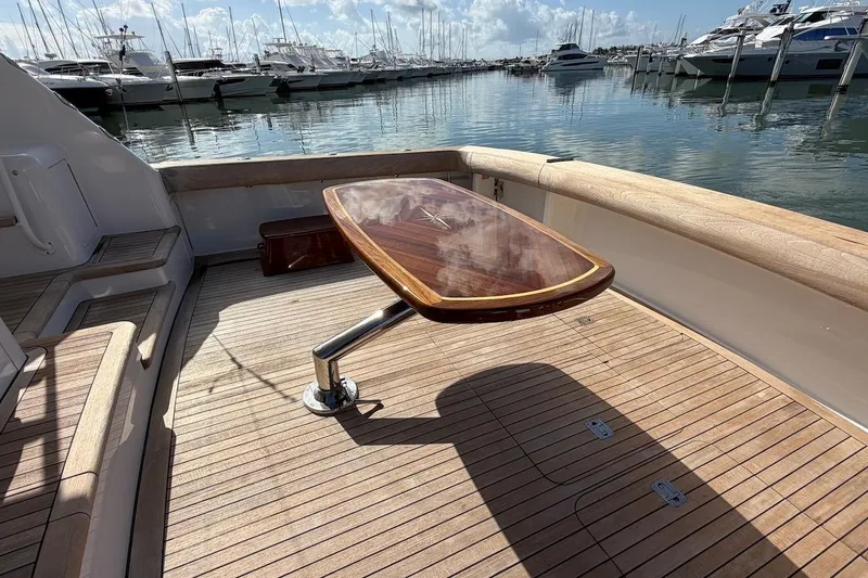 Breakaway Yacht Photos Pics Teak deck and table on 2004 Viking 56 Convertible yacht at marina.