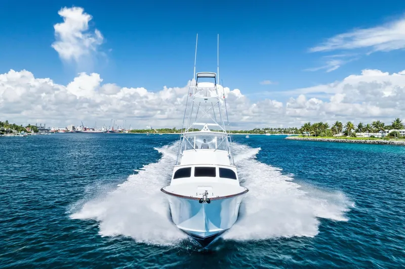 Nic-nac Yacht Photos Pics 1977 Merritt Sportfish yacht cruising on blue ocean under clear sky.