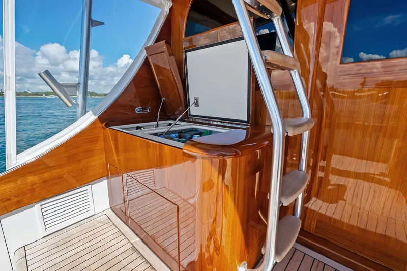 Nic-nac Yacht Photos Pics 1977 Merritt Sportfish boat with polished wood finish and stainless steel ladder.