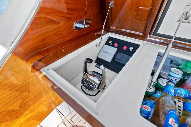 Nic-nac Yacht Photos Pics 1977 Merritt Sportfish boat control panel with Garmin system and beverage storage.