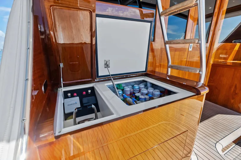 Nic-nac Yacht Photos Pics 1977 Merritt Sportfish boat with open cooler, wooden finish, and ladder.