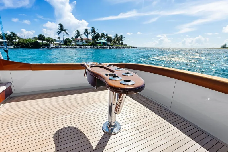 Nic-nac Yacht Photos Pics 1977 Merritt Sportfish yacht deck with ocean view and fishing rod holders.