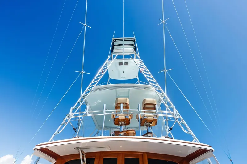 Nic-nac Yacht Photos Pics 1977 Merritt Sportfish yacht with tower against clear blue sky.