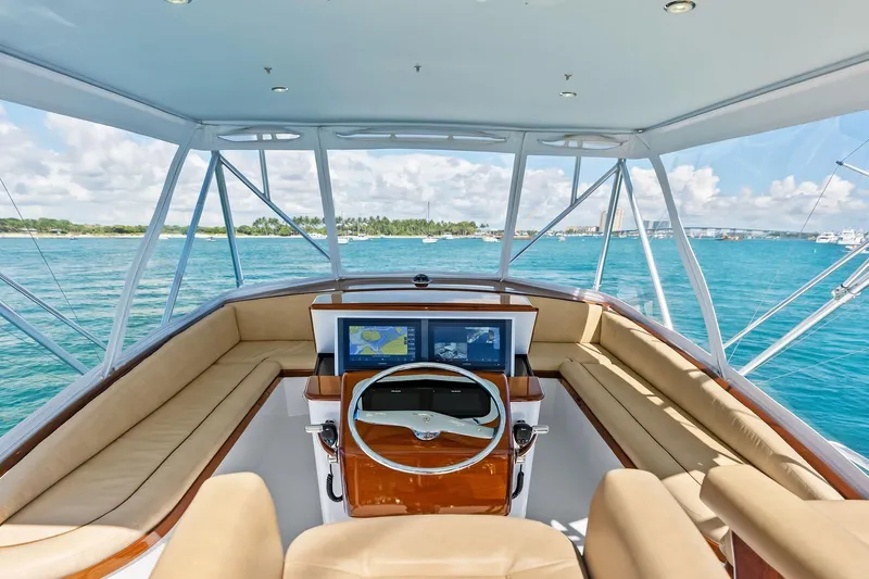 Nic-nac Yacht Photos Pics 1977 Merritt Sportfish yacht helm with panoramic ocean view and modern navigation equipment.