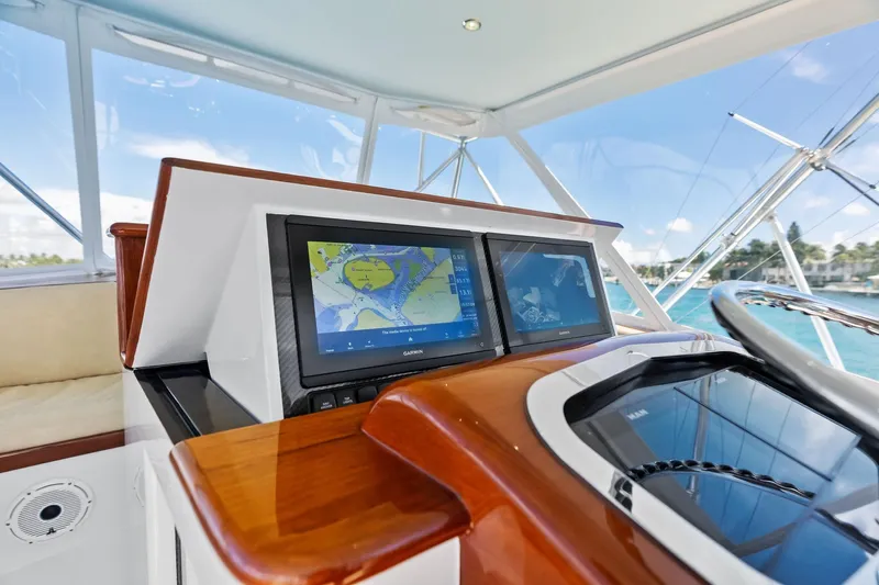 Nic-nac Yacht Photos Pics Helm of 1977 Merritt Sportfish with modern navigation screens and ocean view.