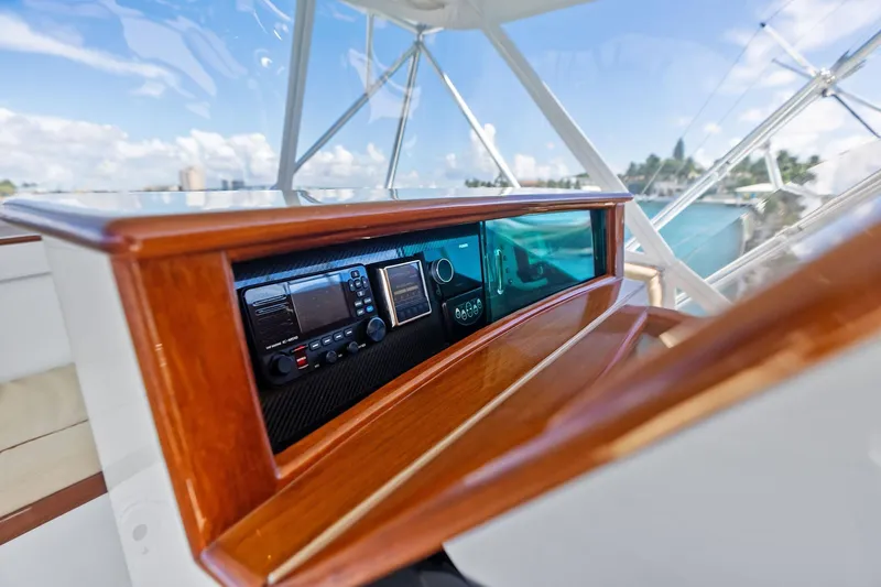 Nic-nac Yacht Photos Pics 1977 Merritt Sportfish helm with modern navigation equipment and polished wood finish.