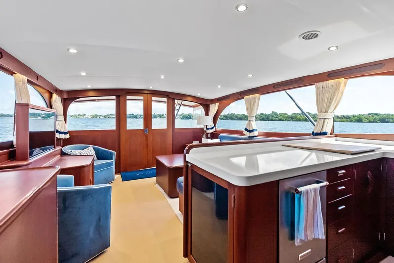 Nic-nac Yacht Photos Pics Luxurious 1977 Merritt Sportfish yacht interior with elegant wood finishes and scenic water views.